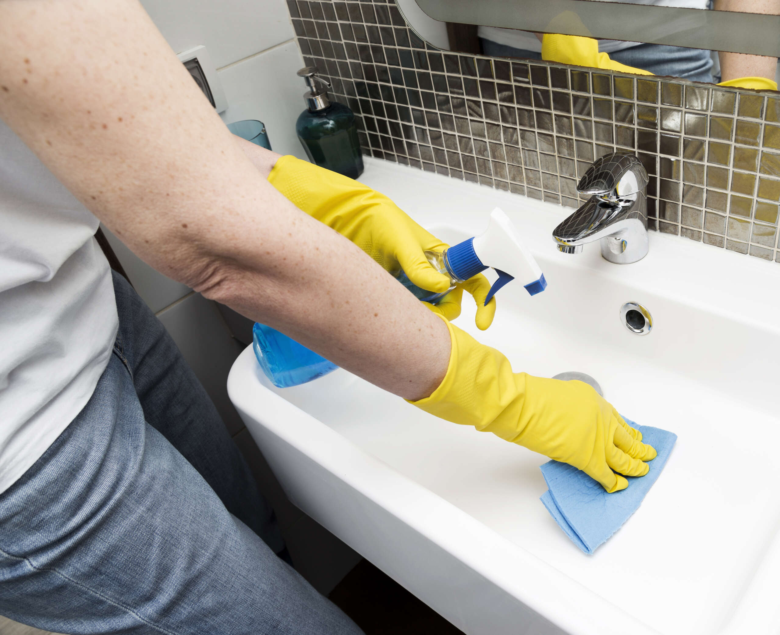 woman-with-rubber-gloves-cleaning-sink